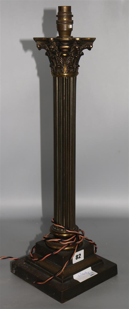 A brass Corinthian column candlestick